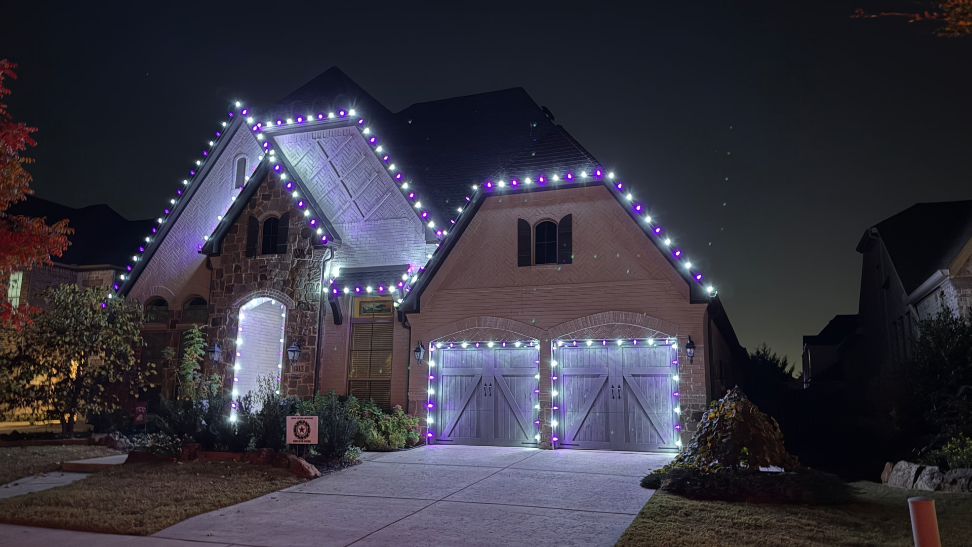 Purple and white custom color roofline and garage lighting at night